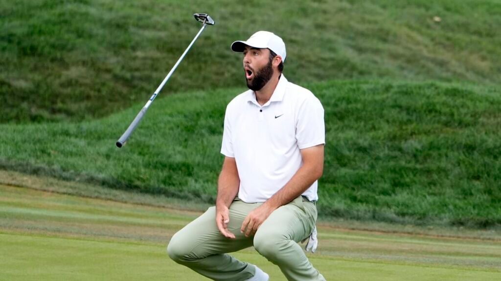 Scottie Scheffler flips his club after missing a birdie putt on the 18th green during the Final round of The Players Championship golf tournament Sunday, March 17, 2024, in Ponte Vedra Beach, Fla.