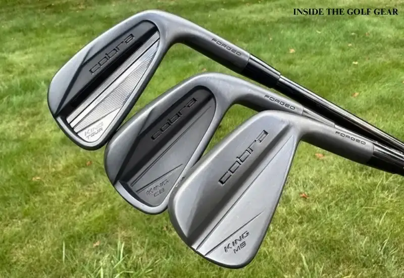 Three golf clubs on grass